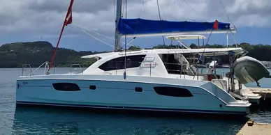 white leopard catamaran with blue sail cover for a yacht delivery by yacht delivery solutions in the south pacific